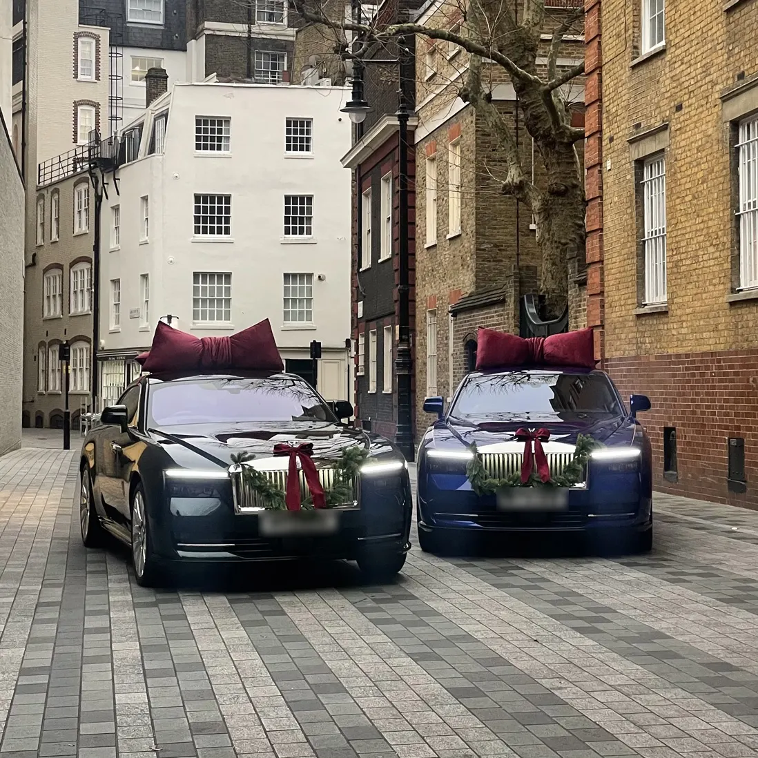 Two dressed cars parked on a cobbled London street