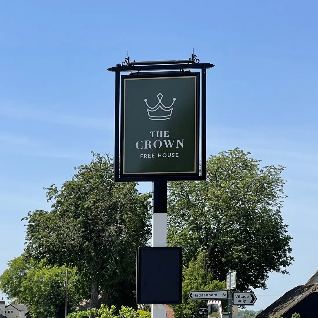The Crown pub - the new hanging sign against open sky